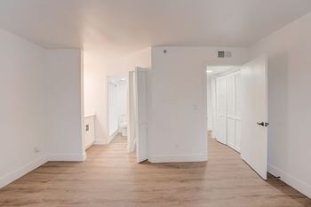 a renovated living room with white walls and wood floors